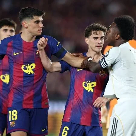 Vinicius Jr discutindo com jogador do Barcelona durante o El Clássico
